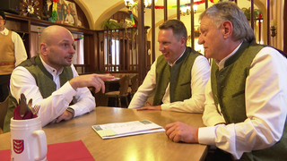 Drei Männer sitzen in einem Wirtshaus in Aitrach
