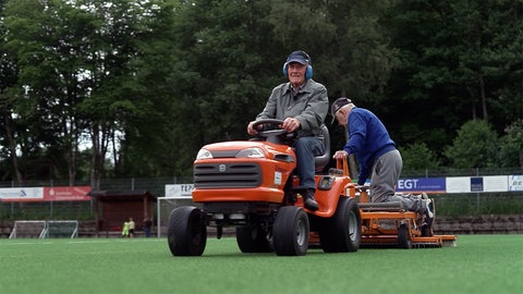 Die Platzwarte Waldemar und Enzo fahren über den Sportplatz in Unterkirnach. Die beiden sind über 80 Jahre alt.