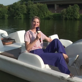 Frau sitzt in einem Tretboot auf der Mosel