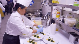 Köchin bereit in einer Küche Essen vor.